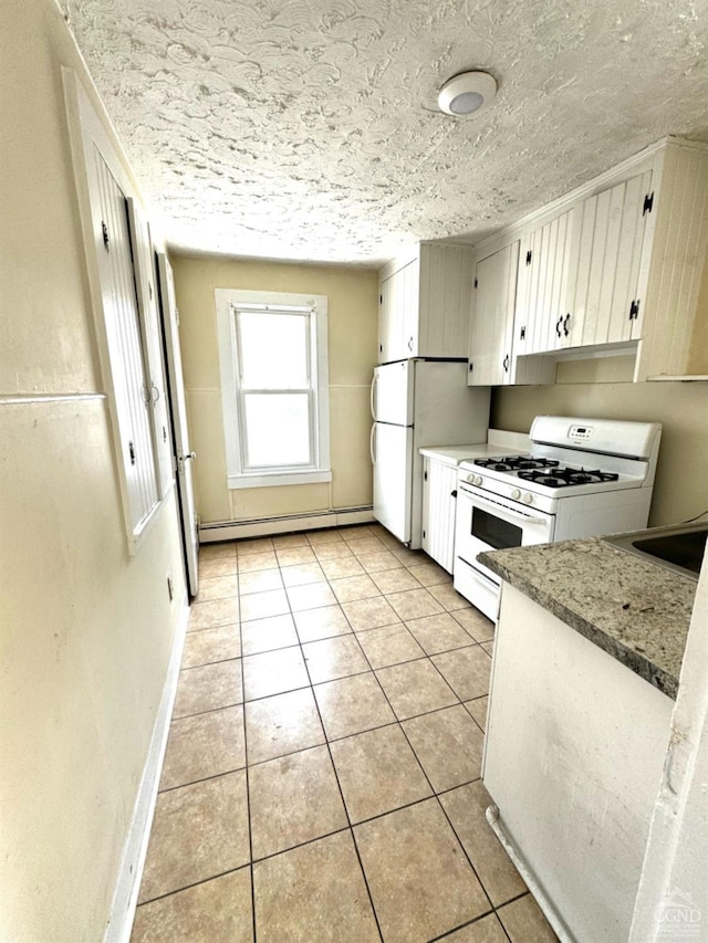 kitchen featuring white cabinetry, a baseboard radiator, light stone counters, white appliances, and light tile patterned floors