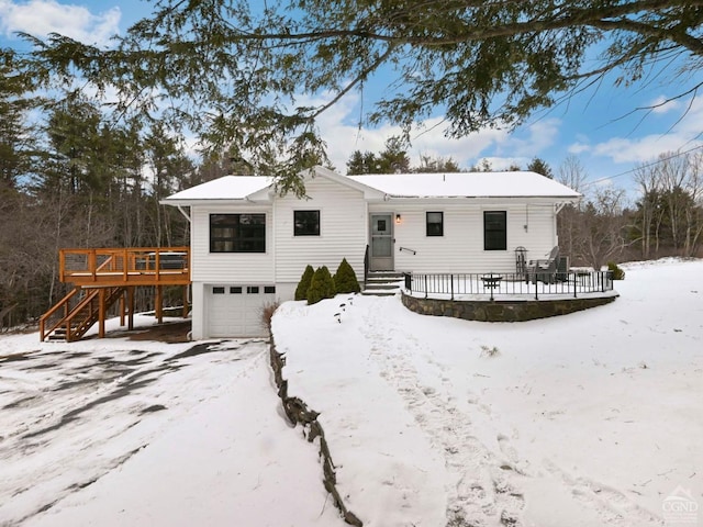 view of front of house with a garage and a deck