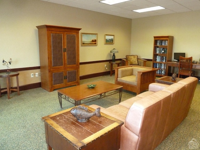 living room with carpet and a paneled ceiling