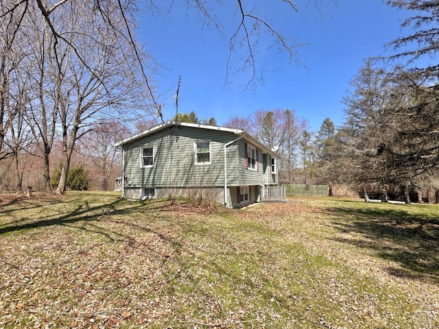 view of side of property with a lawn