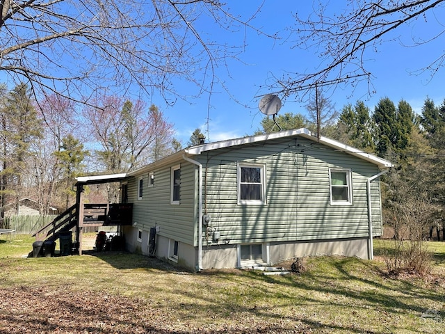 view of side of property with a lawn