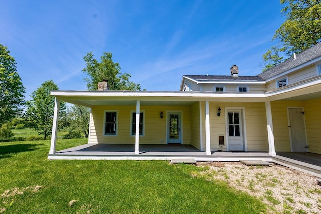 rear view of house with a yard