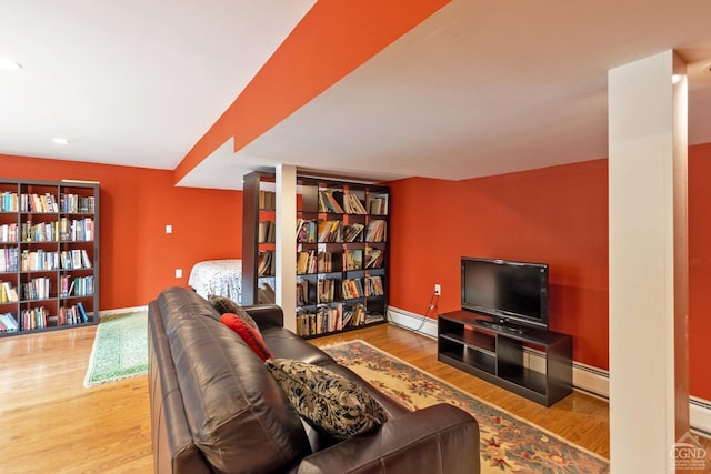 living room featuring a baseboard radiator and hardwood / wood-style flooring