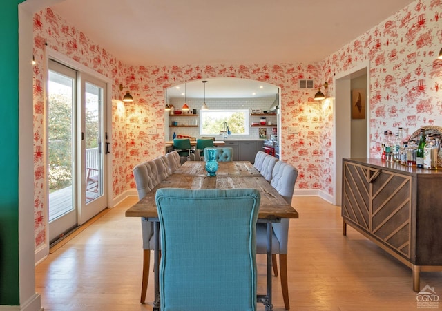 dining area with light hardwood / wood-style flooring and sink