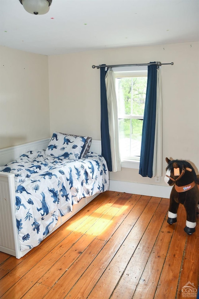 bedroom with hardwood / wood-style floors