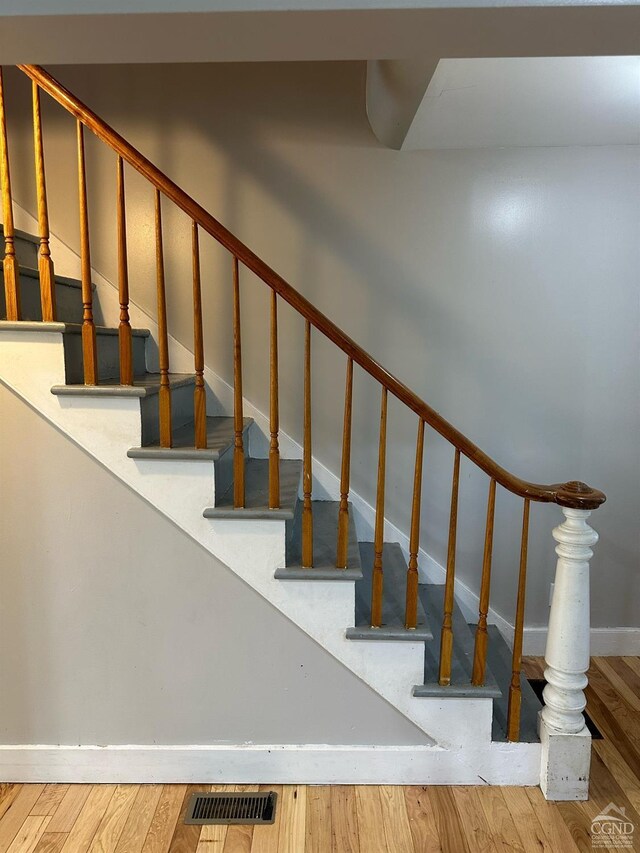 staircase featuring wood-type flooring