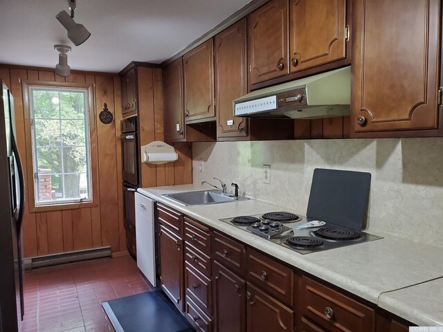 kitchen featuring stainless steel fridge, white dishwasher, double oven, electric stovetop, and sink