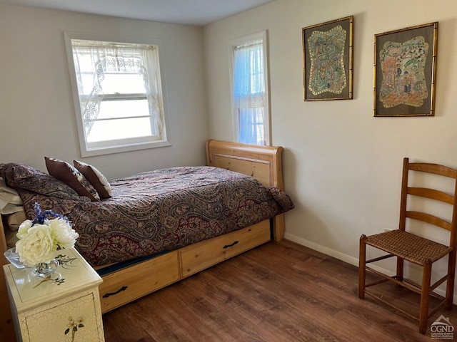 bedroom with dark hardwood / wood-style flooring