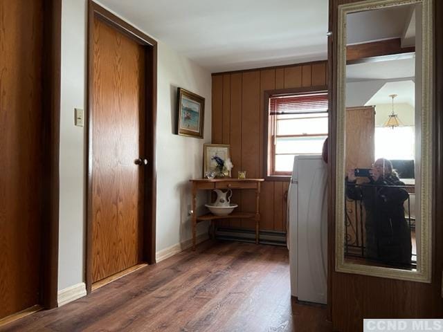 corridor featuring dark hardwood / wood-style floors and baseboard heating