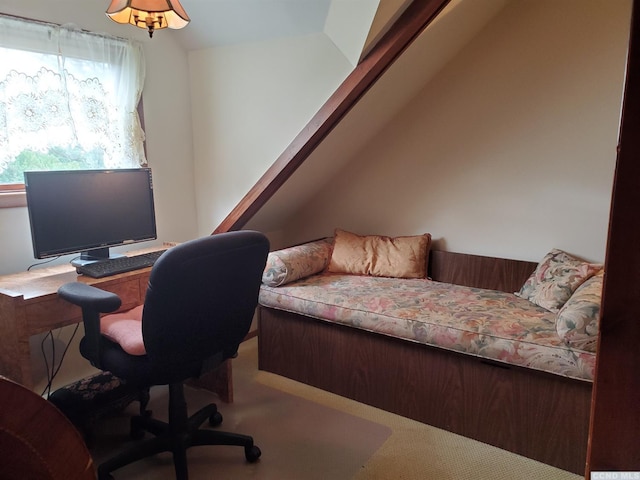 carpeted office space with vaulted ceiling