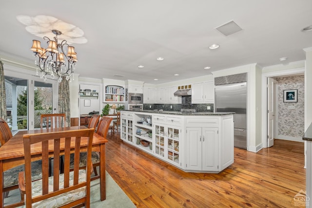 dining room with crown molding, baseboards, recessed lighting, light wood-style floors, and a notable chandelier