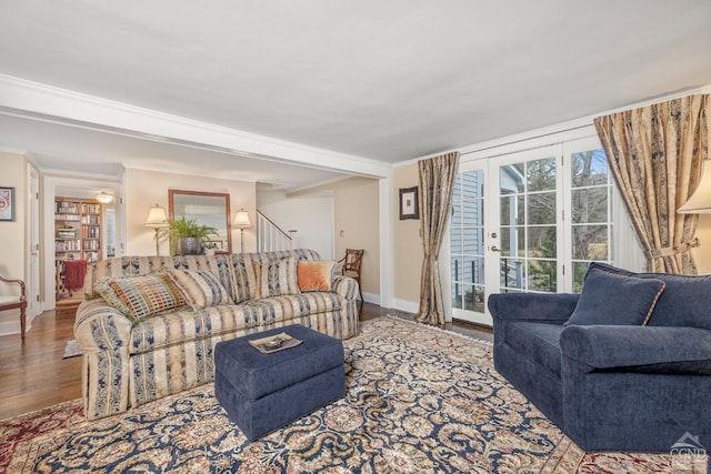 living room featuring french doors, crown molding, baseboards, and wood finished floors