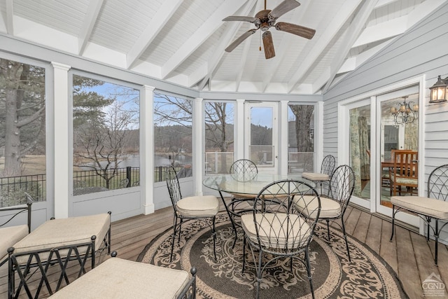 sunroom / solarium featuring wood-type flooring, plenty of natural light, and vaulted ceiling with beams