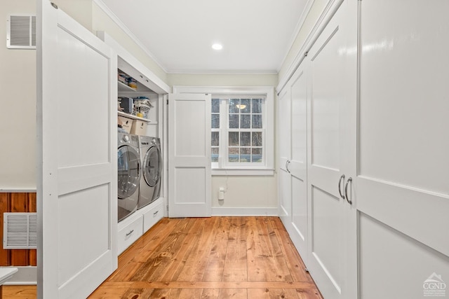 laundry area with independent washer and dryer, crown molding, light wood-style flooring, and visible vents