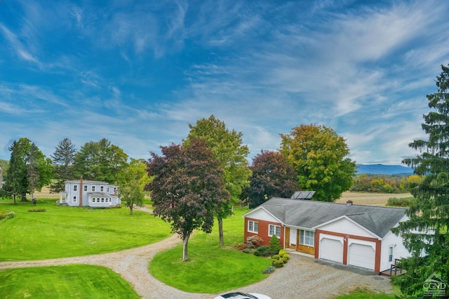 view of front of home with a garage and a front yard