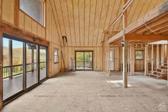 misc room with high vaulted ceiling and a healthy amount of sunlight