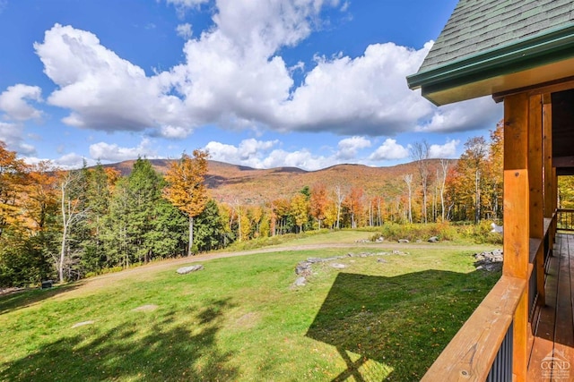 view of yard featuring a deck with mountain view