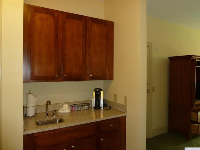 kitchen with light stone counters and sink