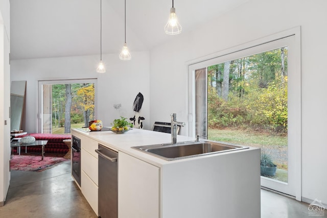 kitchen featuring pendant lighting, white cabinetry, plenty of natural light, and a kitchen island with sink