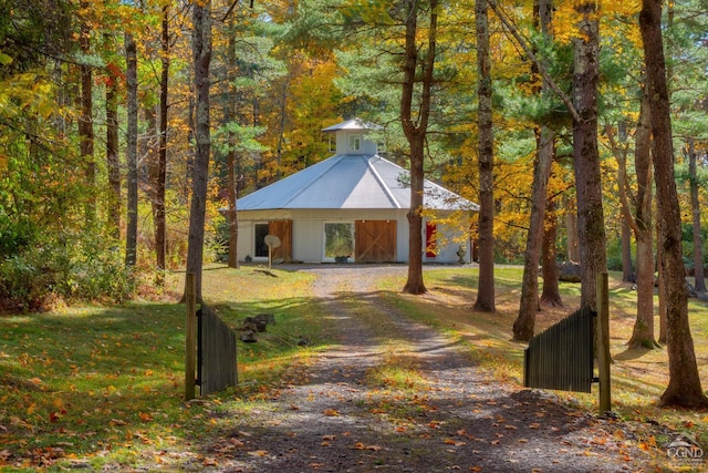 surrounding community featuring a lawn and an outbuilding