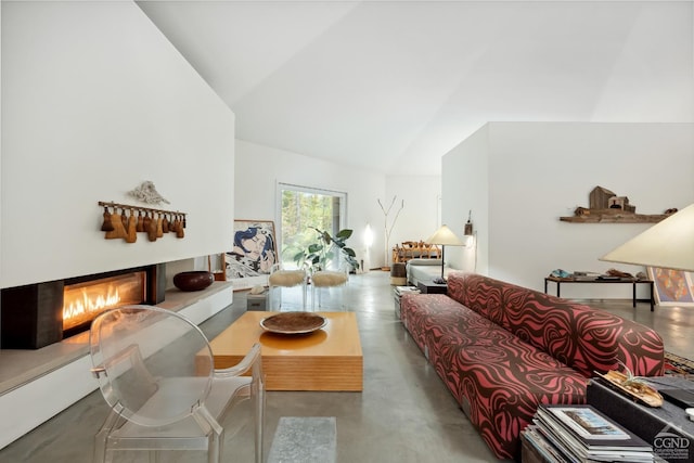 living room featuring concrete flooring and vaulted ceiling