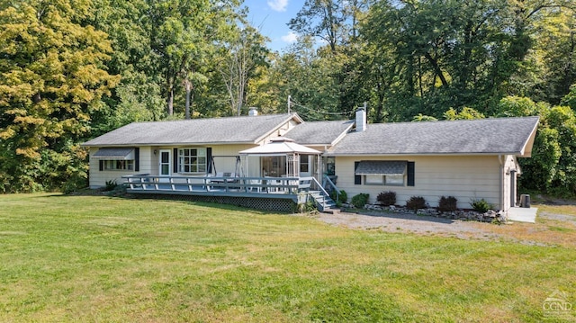 single story home featuring a deck and a front lawn