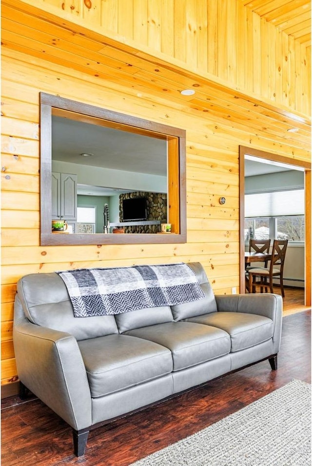 living room featuring dark hardwood / wood-style floors and wood walls