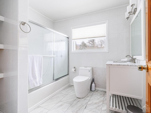 full bathroom with toilet, combined bath / shower with glass door, crown molding, tile walls, and vanity