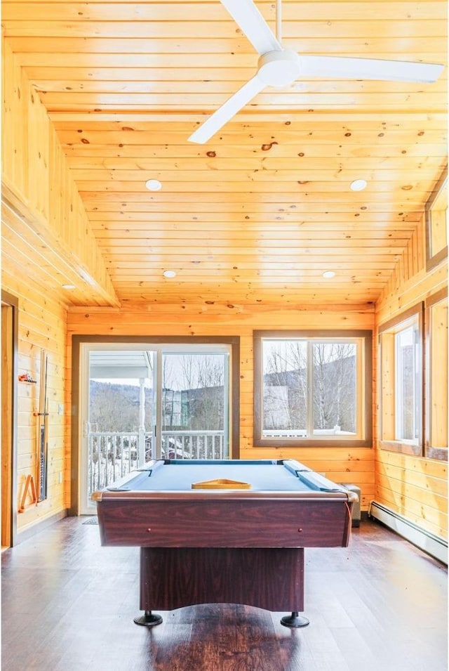 game room featuring baseboard heating, wooden ceiling, and wood walls