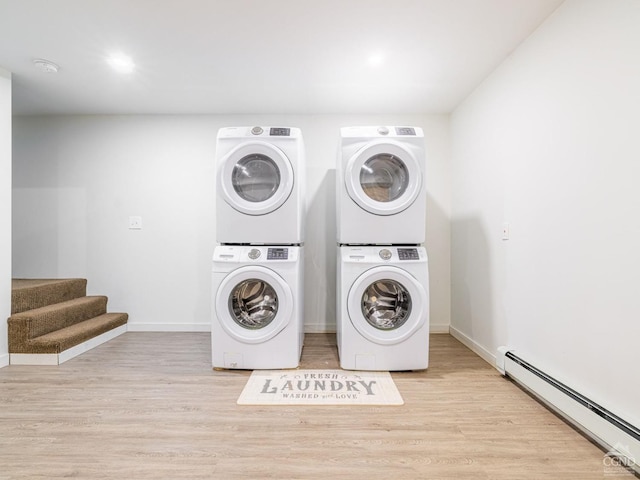 clothes washing area with stacked washer / dryer, a baseboard heating unit, and light wood-type flooring