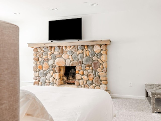 room details featuring a fireplace and carpet