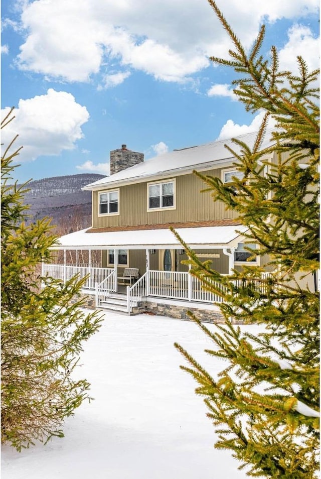 view of front of house featuring a porch and a mountain view