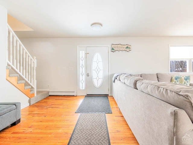 entryway featuring a baseboard heating unit and light wood-type flooring