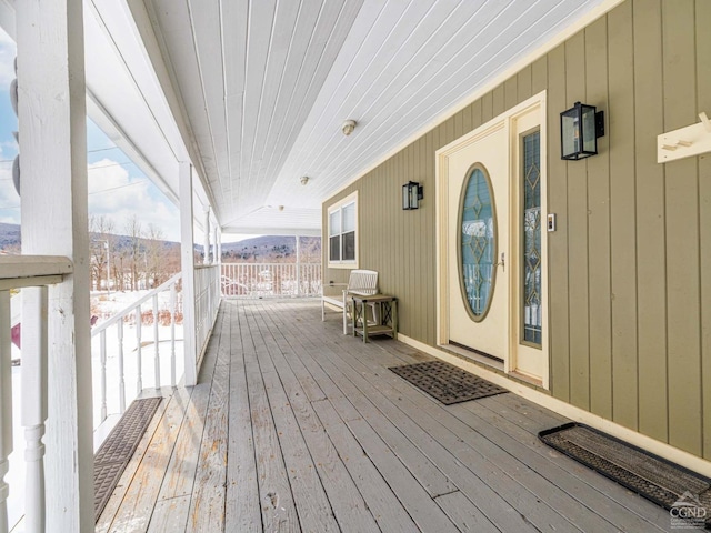 snow covered deck with covered porch