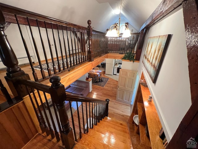 staircase with a baseboard radiator, wood-type flooring, lofted ceiling, and an inviting chandelier