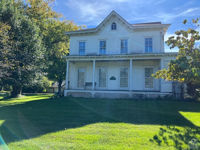 italianate-style house with a front yard and a porch