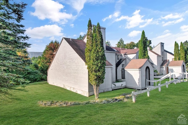 exterior space featuring a lawn and a shed