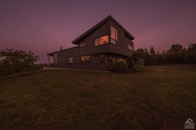 back house at dusk with a yard