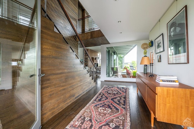 corridor featuring wood walls and dark hardwood / wood-style flooring