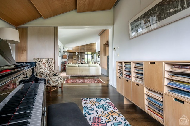 interior space with light brown cabinets, vaulted ceiling with beams, dark wood-type flooring, and wood ceiling