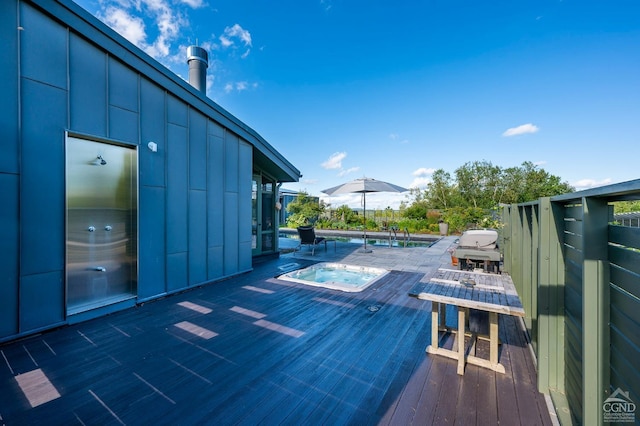 view of pool with an in ground hot tub and grilling area