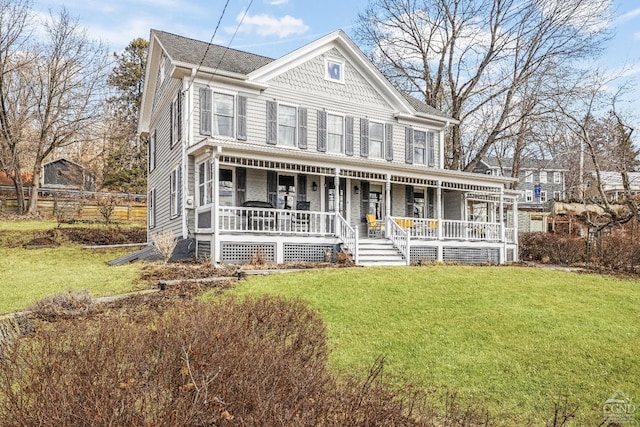 victorian-style house with a porch and a front lawn