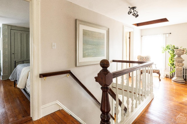 stairs with baseboards and hardwood / wood-style floors