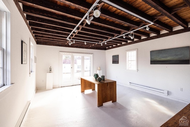 office space with a baseboard radiator, wooden ceiling, finished concrete flooring, and track lighting