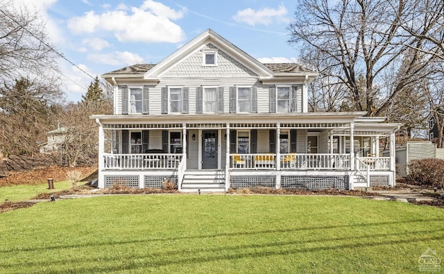 victorian-style house featuring a front lawn and covered porch