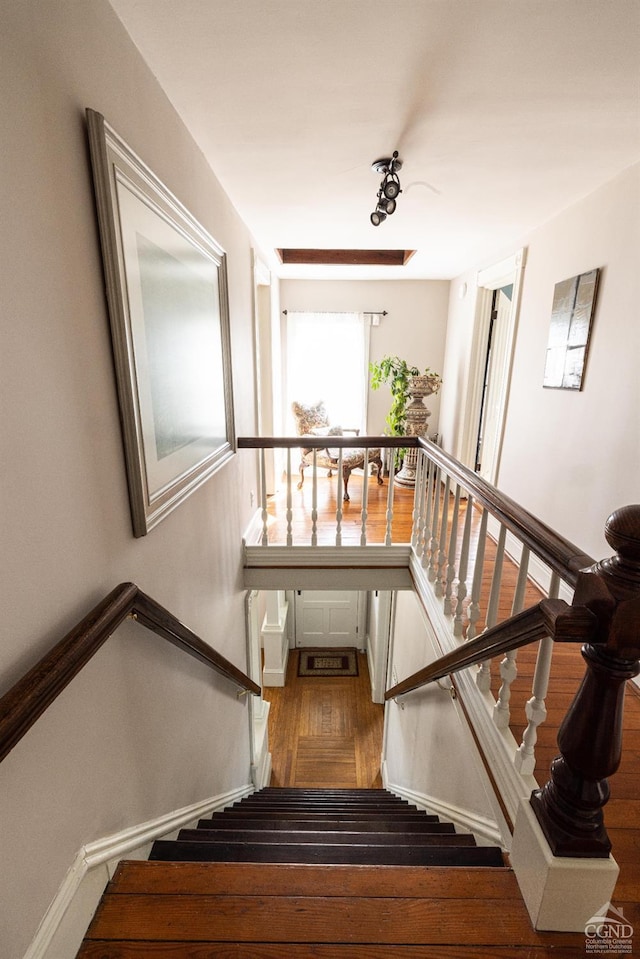 stairs with wood finished floors