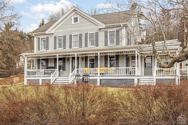 victorian home featuring covered porch and a shingled roof