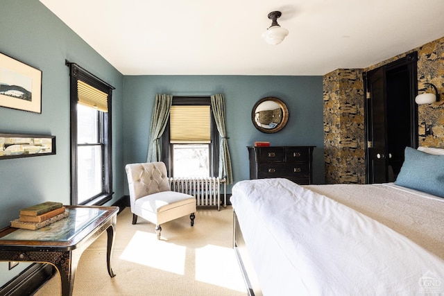 carpeted bedroom featuring multiple windows and radiator