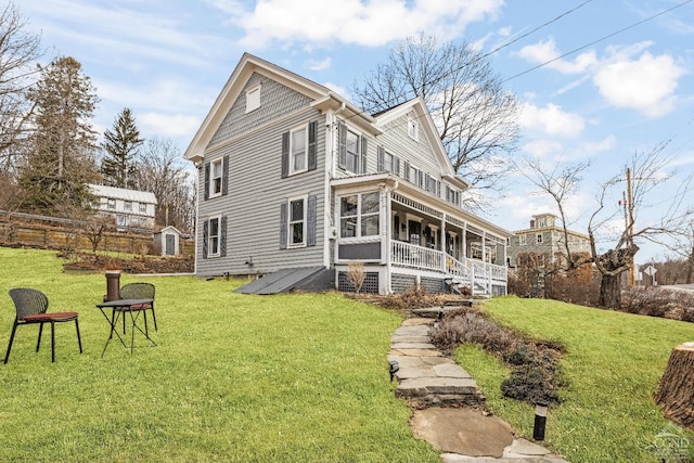 back of house with a lawn and a porch