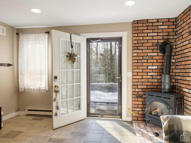 entryway featuring visible vents, baseboards, a baseboard radiator, a wood stove, and recessed lighting